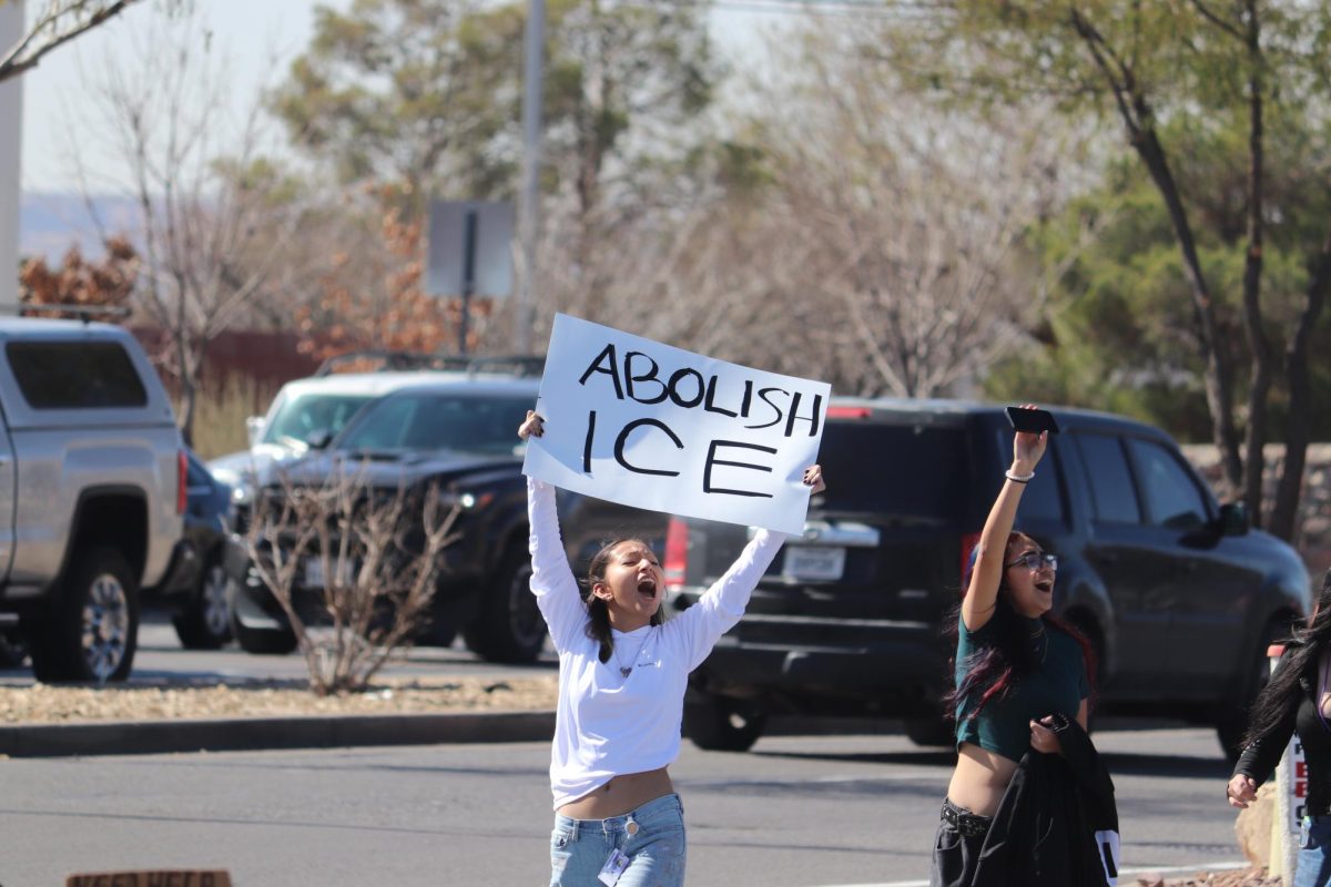 A student holds an "Abolish ICE" sign on Jan. 30 after a coordinated walk out during school.